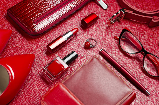 Woman red accessories, jewelry, cosmetic, shoes and other luxury objects on leather background, fashion industry, modern female concept, selective focus 