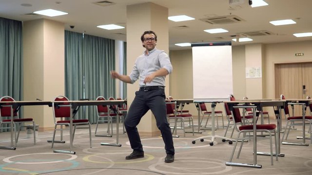 Man performing funny dance in education room