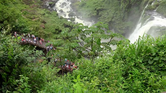 Tourists at the  lower  circuit trail of Iguazu Falls. View from the upper circuit trail. Argentina.