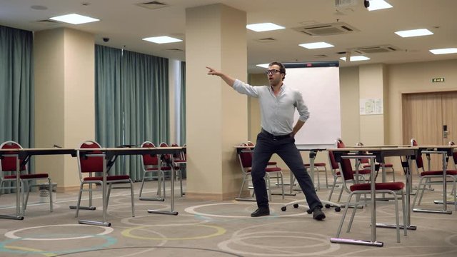 Man performing funny dance in education room