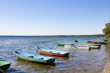 Fototapeta na wymiar Colorful boats in summer, Naroch- largest lake in Belarus