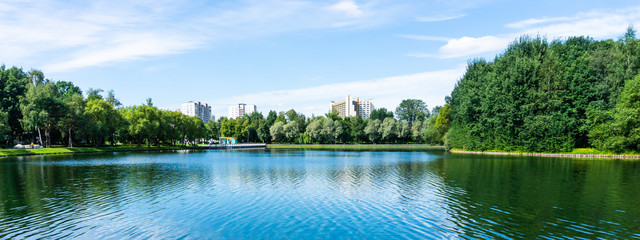 Panorama of big park and lake in megapolis at summer