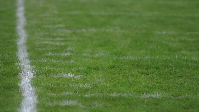 Football field sideline with yard hash marks, close up