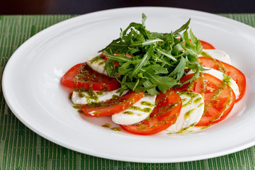 Caprese: light snack including tomatoes, mozzarella, olive oil and basil.