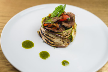 meat with grilled vegetables, on a white plate