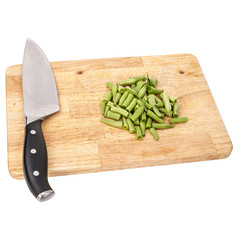 Fresh green beans on a cutting board on a table, white isolated background