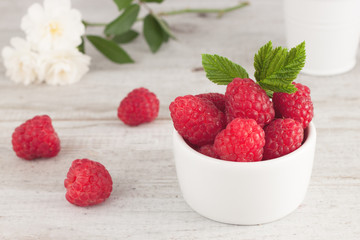 Raspberry in bowl. Raspberry on blue bacground with copy space for text.