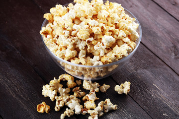 Cinema concept with popcorn on rustic table