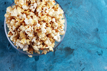 Cinema concept with popcorn on rustic table