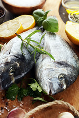 Delicious fresh fish. Fish with aromatic herbs, spices and vegetables - healthy food, diet or cooking concept.