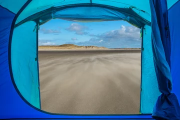Foto auf Acrylglas View from inside a tent onto a beach in Texel, the Netherlands. © Erik_AJV
