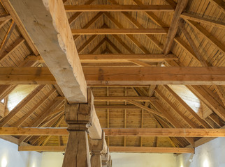 Obraz na płótnie Canvas massive timber structure timberwork of roof on old baroque farm house made