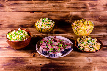 Different festive dishes on a wooden table