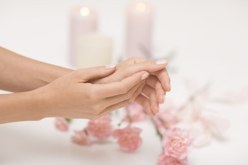 Skin care for hands. Closeup image of beautiful woman's hands with light pink manicure.