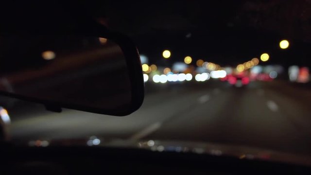 Rear view mirror at night driving on the highway, in slow motion