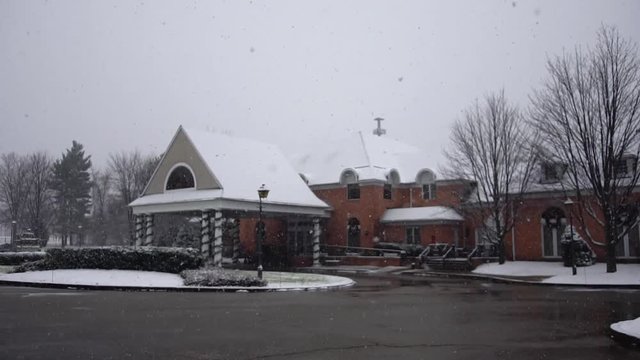 Exterior of a country club in a snow storm, in slow motion