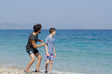Two brothers having fun at the beach.