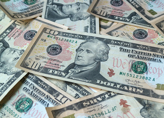 Close up pile of United States ten dollar ($10) bills, for background or banner