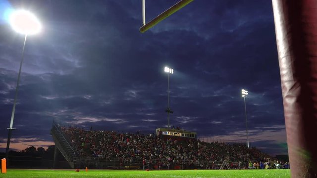 Full high school stadium at dusk dolly