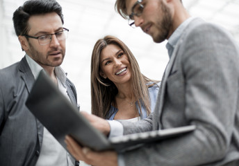employees using a laptop to obtain the necessary information