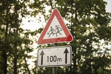 Road sign with image of the children who run across the road