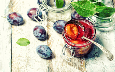 Plums jam fresh fruits wooden background vintage