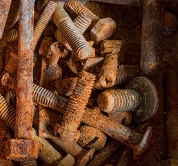 rusty dirty bolts and nuts lie together