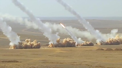 Truck based anti aircraft missile launchers fire in the desert.