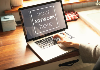 Woman Using Laptop on Kitchen Counter Mockup - Powered by Adobe