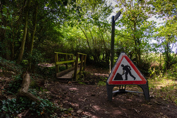 Unusual roadsign in forest public footpath