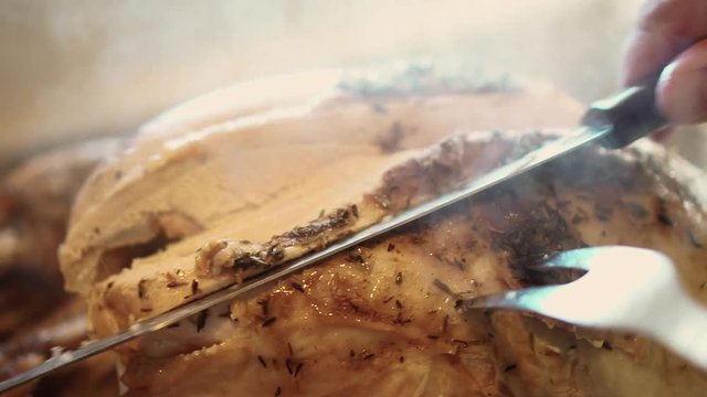 Carving the breast of a turkey close up, in slow motion