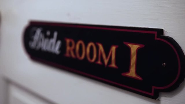 "Brides Room" sign hanging on a door