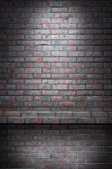 Light of a searchlight on a brick wall in an old room. Brick wall background with light spot.