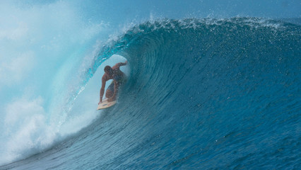 CLOSE UP: Stunning emerald water curls over surfer riding inside a barrel wave