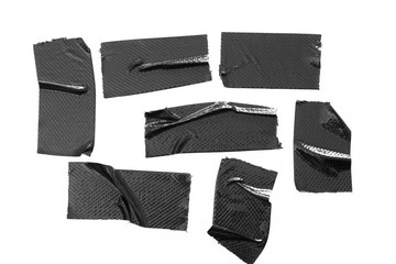 Set of black tapes on white background. Torn horizontal and different size black sticky tape, adhesive pieces.