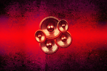 Red music speakers on a concrete wall