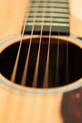 Obraz premium The Strings and Sound Hole of a Guitar - Close Up