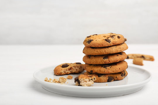 Plate with tasty chocolate cookies on light table
