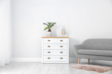 Chest of drawers in stylish living room interior