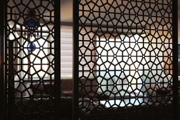 Interior of living room, view through decorative room divider