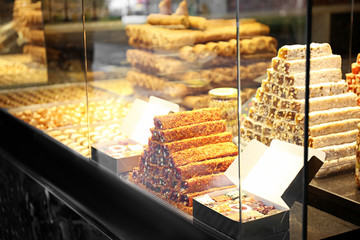 Showcase with different fresh Turkish desserts, closeup