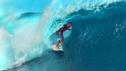 CLOSE UP: Young pro surfboarder rides a breathtaking barrel wave in Tahiti.