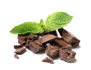 Pieces of milk chocolate with mint on white background