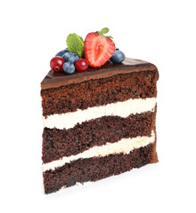 Slice of chocolate sponge cake with berries on white background