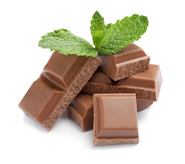 Pieces of milk chocolate with mint on white background