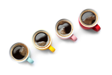 Row of cups with aromatic coffee on white background, top view