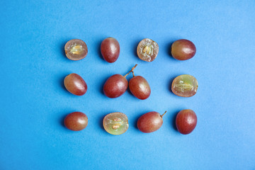 Fresh ripe juicy grapes on color background, top view