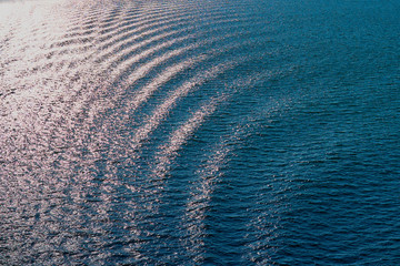 Fototapeta na wymiar Waves on a sea water in sunlight.