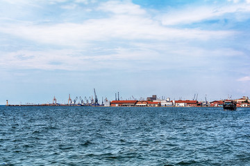Naklejka premium Thessaloniki, Greece - August 16, 2018: Coast of historical cityview with traditional winches at harbour of Thessaloniki, Greece