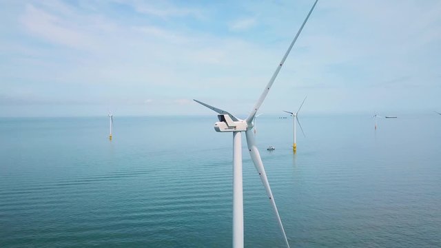 Remarkable drone aerial over windmills and turbines in the ocean off the coast of England.